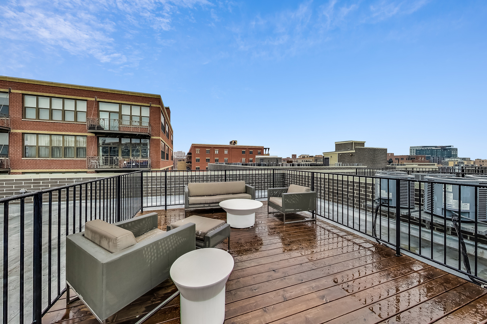 1247 West Madison Street, Unit 211 Chicago, IL 60607 - Photo 16 of 17 a balcony with table and chairs