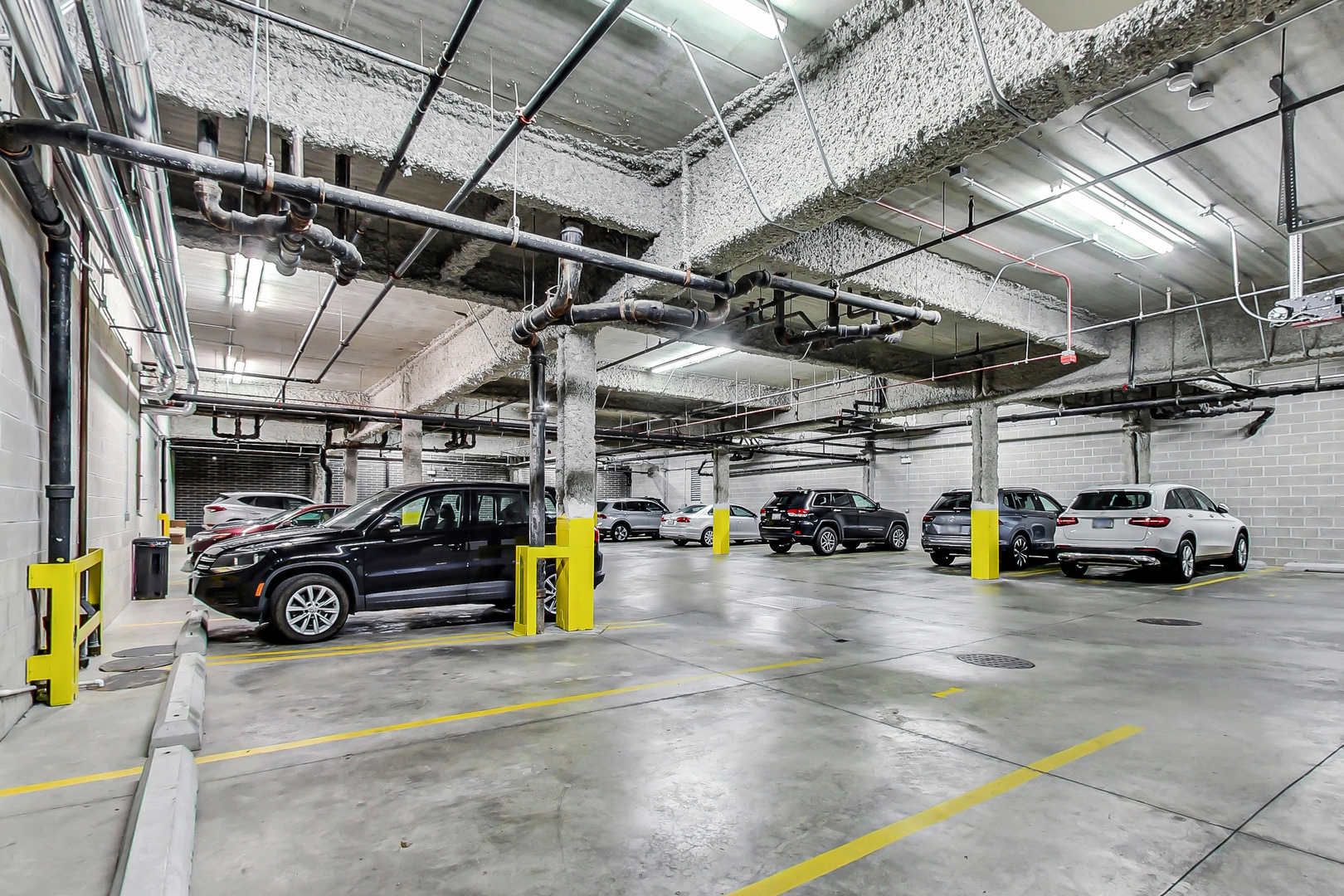 1247 West Madison Street, Unit 211 Chicago, IL 60607 - Photo 17 of 17 a view of parking garage with cars
