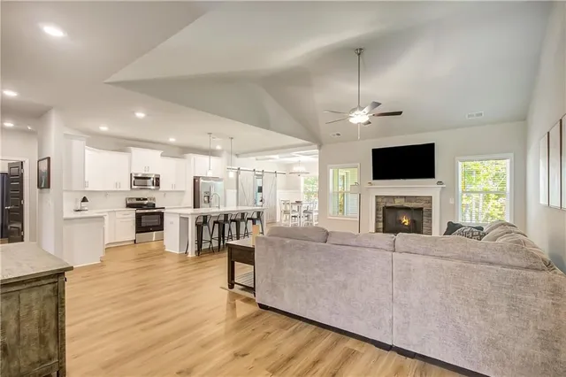 a living room with furniture a fireplace and a flat screen tv