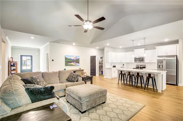 a living room with furniture kitchen view and a dining table
