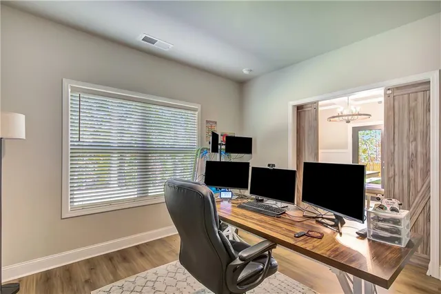 a view of a workspace with furniture and a window