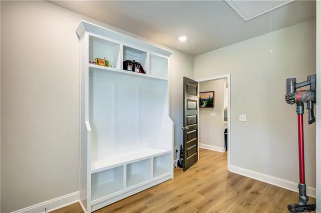 a view of a kitchen with wooden floor and a refrigerator