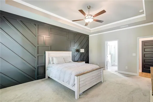 a bedroom with a large bed and a ceiling fan