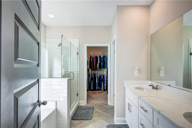a bathroom with a double vanity sink and a mirror