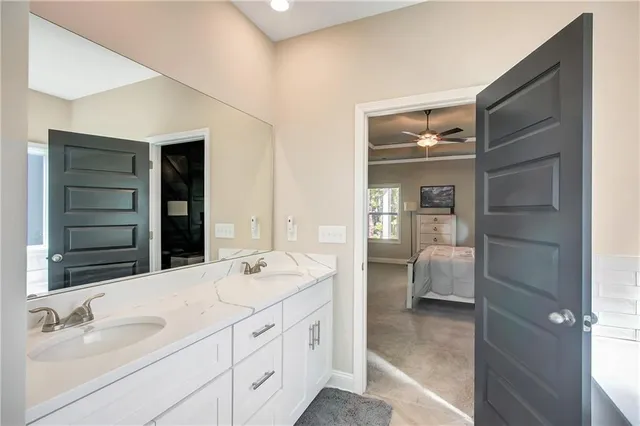 a en suite bathroom with a double vanity sink a mirror and a shower