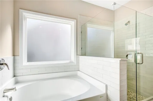 a bathroom with a bathtub and shower