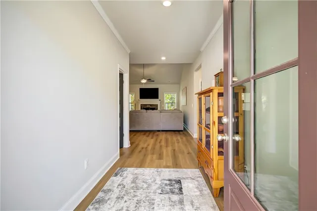 a view of a hallway with wooden floor and staircase