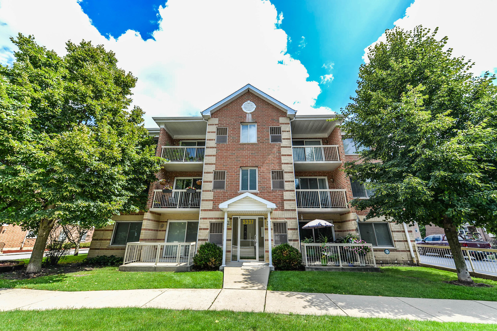 5337 North East River Road, Unit 302 Chicago, IL 60656 - Photo 1 of 22 a front view of a house with a yard