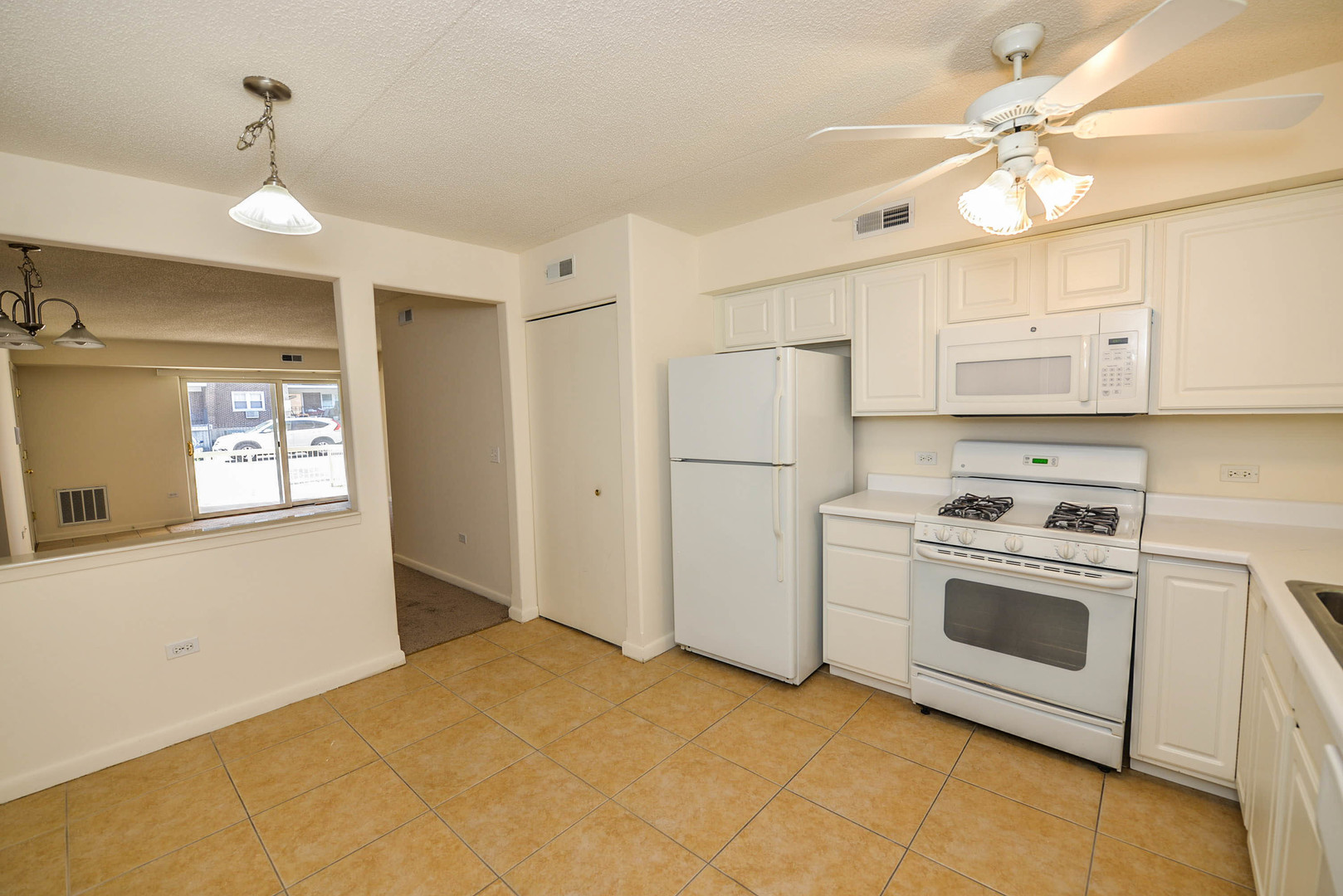 5337 North East River Road, Unit 302 Chicago, IL 60656 - Photo 4 of 22 a kitchen with white cabinets and white appliances