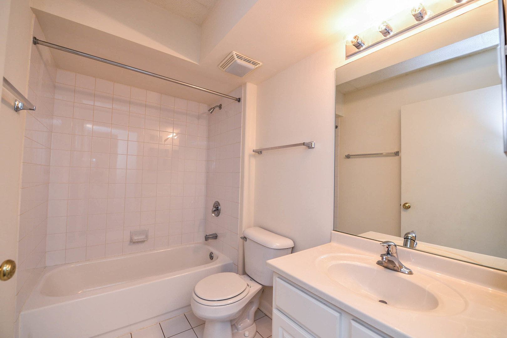 5337 North East River Road, Unit 302 Chicago, IL 60656 - Photo 10 of 22 a bathroom with a bathtub shower sink mirror vanity and toilet