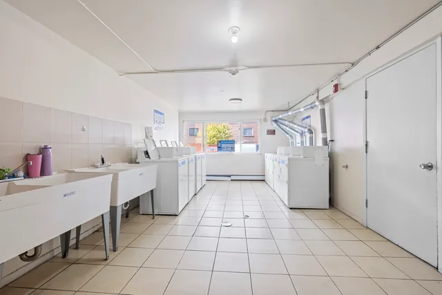 a kitchen with a sink a counter appliances and cabinets