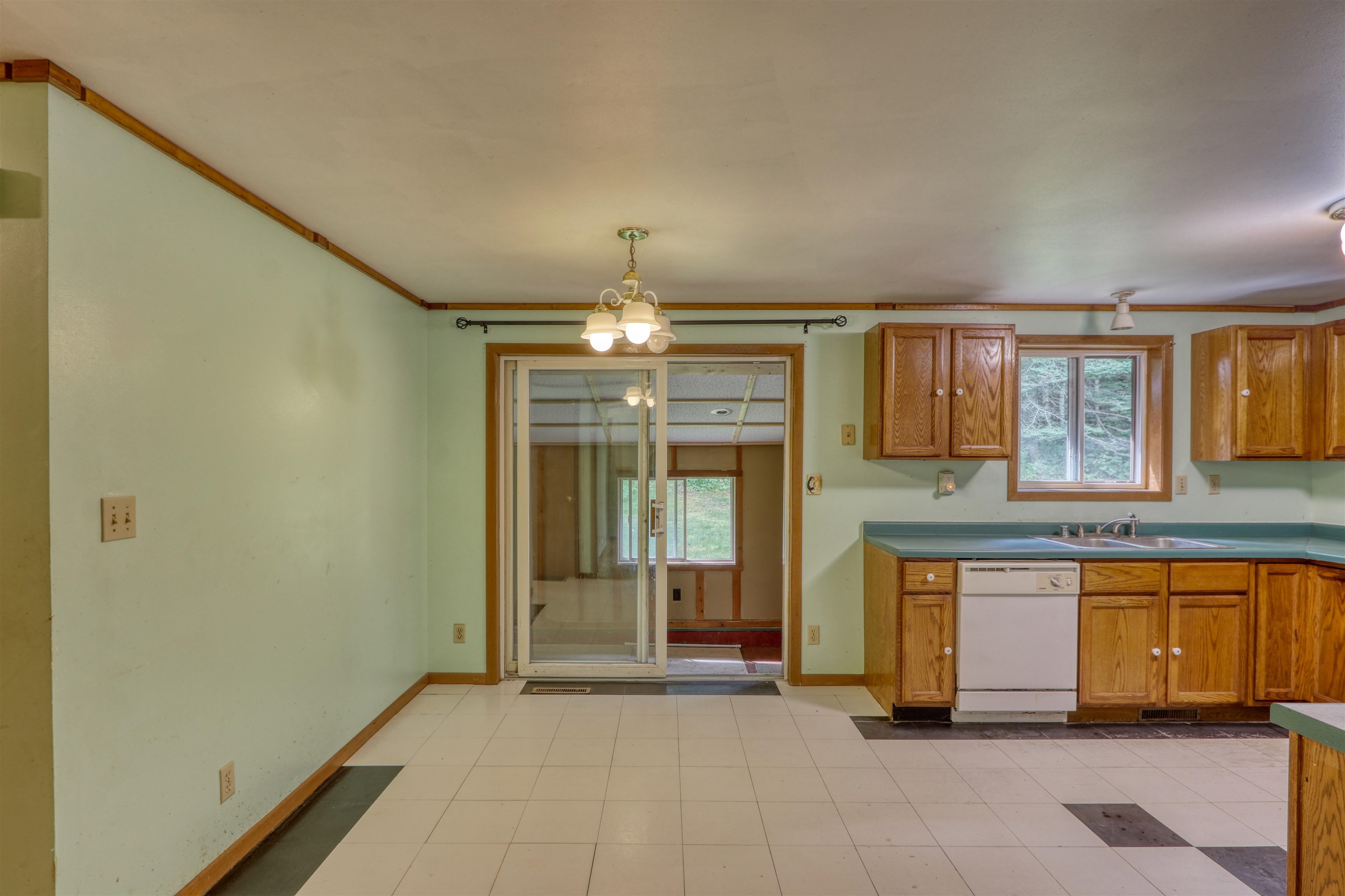 22655 Sunset Acres Lane Grand View, WI 54839 - Photo 14 of 47 Kitchen featuring brown cabinets, healthy amount of natural light, dishwasher, and ornamental molding