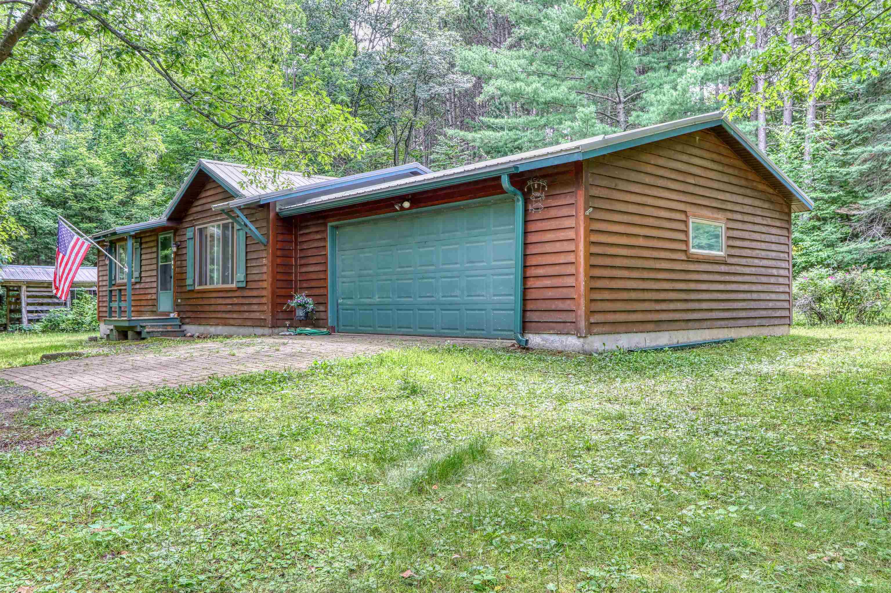 22655 Sunset Acres Lane Grand View, WI 54839 - Photo 35 of 47 Chalet / cabin featuring a front yard, an attached garage, and dirt driveway