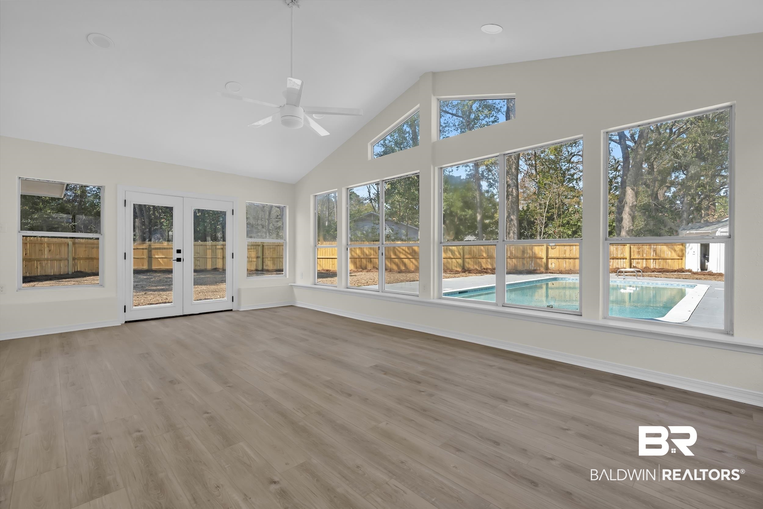 1409 Altair Lane Mobile, AL 36693 - Photo 3 of 23 Unfurnished sunroom with french doors, wood finished floors, and vaulted ceiling
