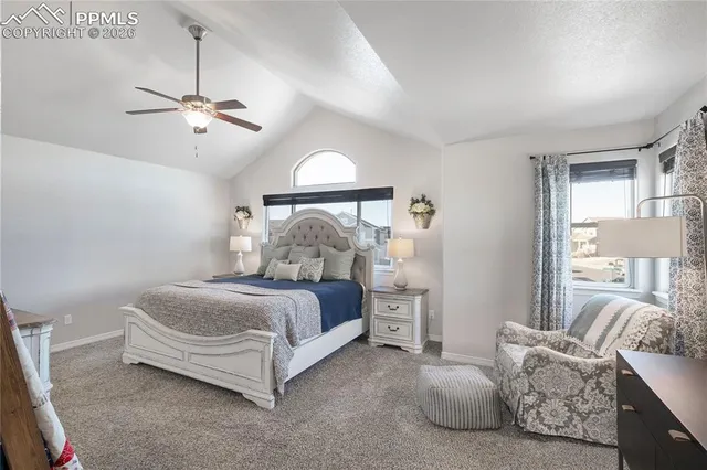 a spacious bedroom with a bed and a chandelier