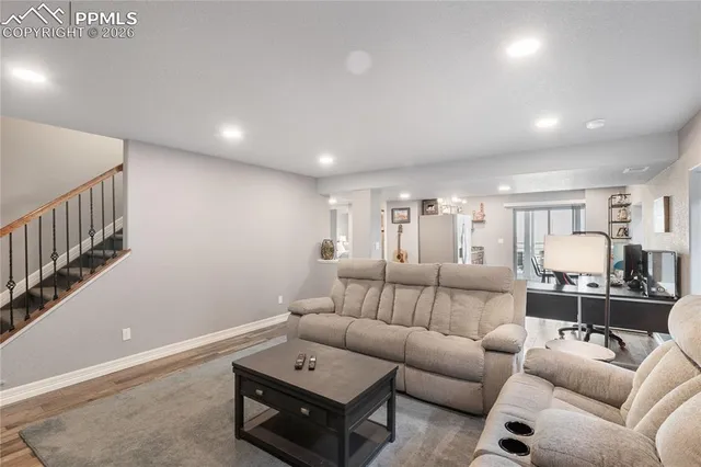 a living room with furniture and wooden floor
