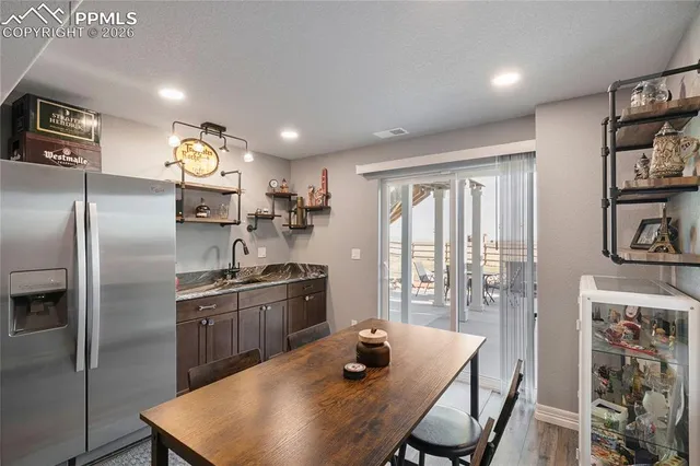 a kitchen with stainless steel appliances granite countertop a sink a stove and refrigerator