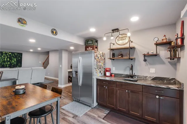 a kitchen with a refrigerator and a stove top oven