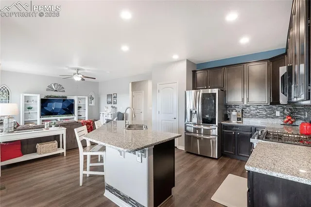 a kitchen with refrigerator cabinets and wooden floor