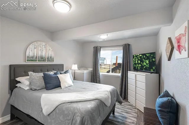 a bedroom with a large bed and a window