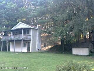 1171 Heart Lake Road Montrose, PA 18801 - Photo 12 of 56 a front view of a house with a garden