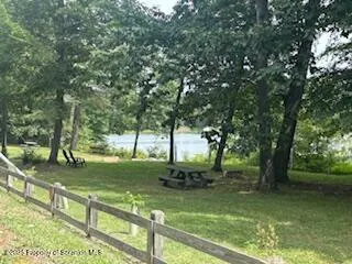 a living room with furniture a lamp and a window