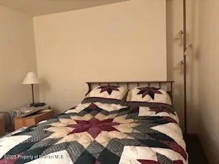 a bed room with a bed and a chair