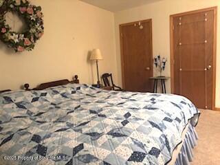 1171 Heart Lake Road Montrose, PA 18801 - Photo 52 of 56 a bedroom with a bed and a chandelier