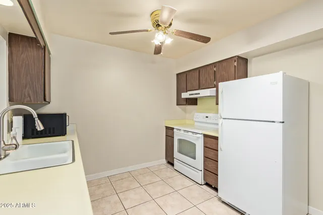 a workspace with a chandelier fan and wooden floor