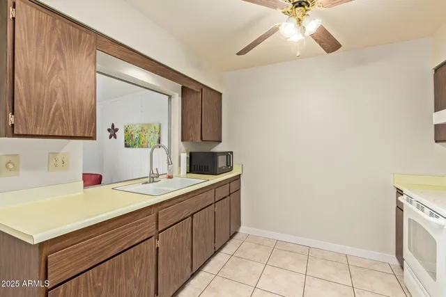a kitchen with a refrigerator sink stove and cabinets