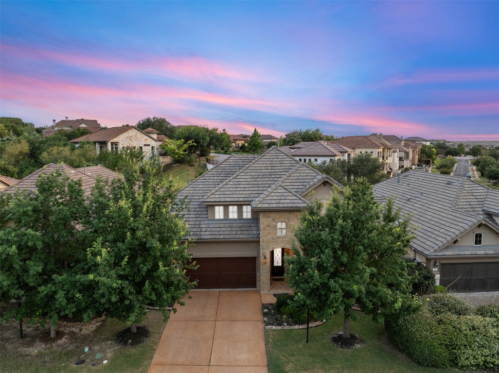 a front view of a house with a yard and mountain view