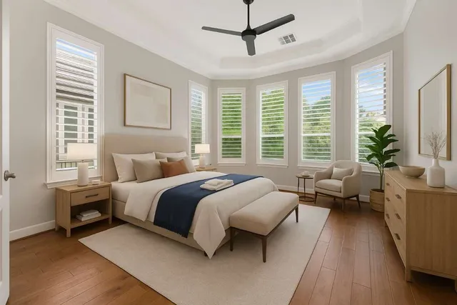 a spacious bedroom with a bed a couch and a window