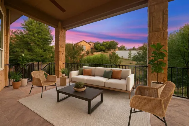 a balcony with table and chairs
