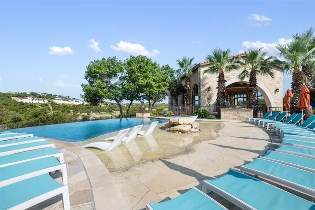 a view of swimming pool with outdoor seating and plants
