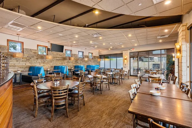 a very nice looking dining room with lots of furniture and wooden floor