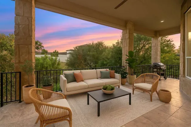 a balcony with table and chairs