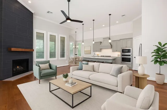 a living room with furniture fireplace and a large window