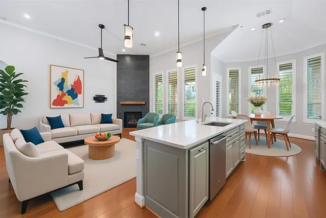 a kitchen with stainless steel appliances granite countertop a sink a stove and a refrigerator