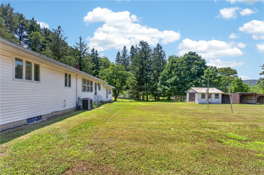 51 Reynolds Road Tamaqua, PA 18252 - Photo 56 of 71 A spacious outdoor area provides ample room for activities, complemented by a convenient shed and covered shelter.