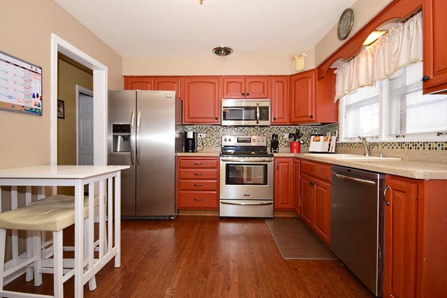 1219 Good Avenue Park Ridge, IL 60068 - Photo 3 of 25 a kitchen with stainless steel appliances a stove a sink dishwasher a refrigerator and wooden floor