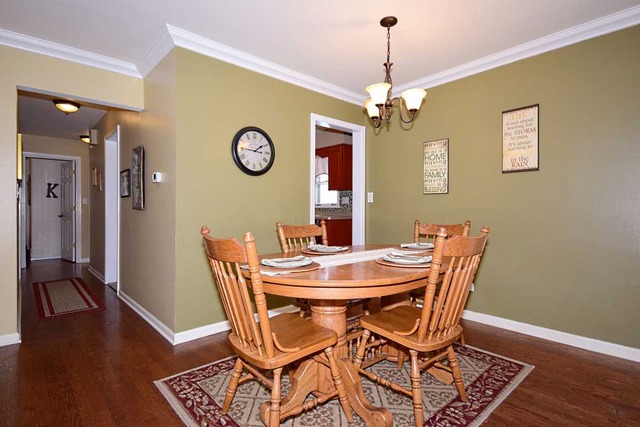 1219 Good Avenue Park Ridge, IL 60068 - Photo 4 of 25 a view of a dining room with furniture wooden floor and a chandelier