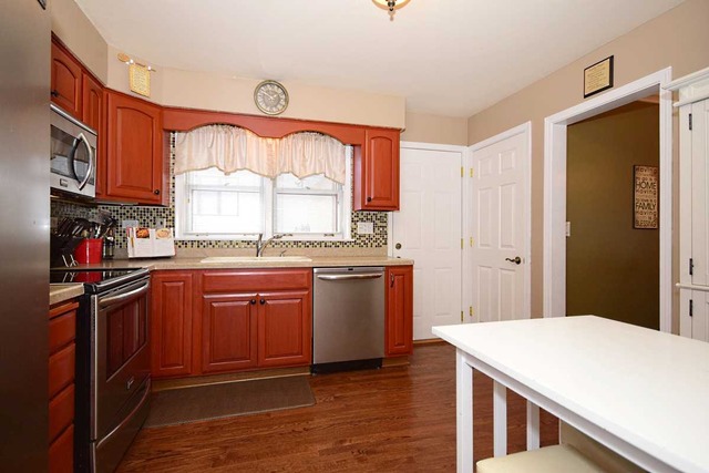 1219 Good Avenue Park Ridge, IL 60068 - Photo 8 of 25 a kitchen with stainless steel appliances granite countertop a stove a sink dishwasher and a refrigerator