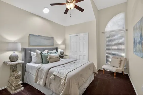 a bedroom with bed and a chandelier