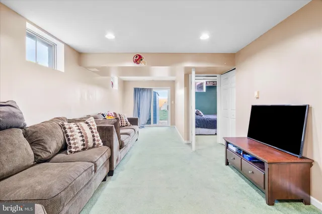 a white toilet sitting next to a white sink and vanity