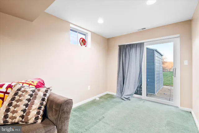 a patio with table and chairs and potted plants