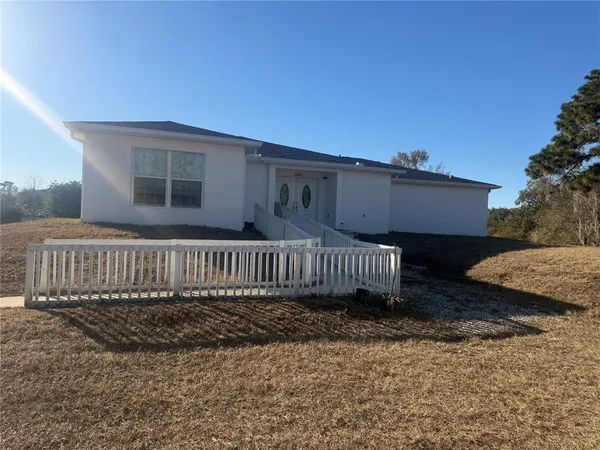 a view of a house with a wooden deck