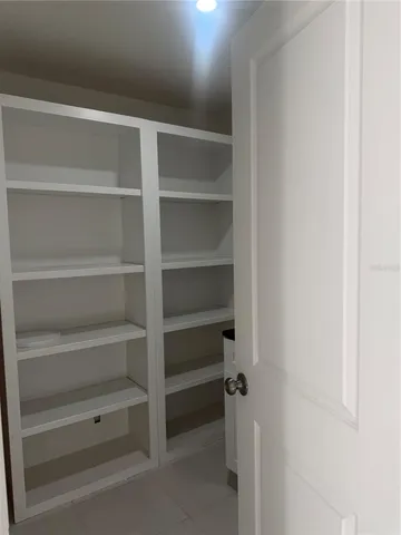a view of an empty room with a closet