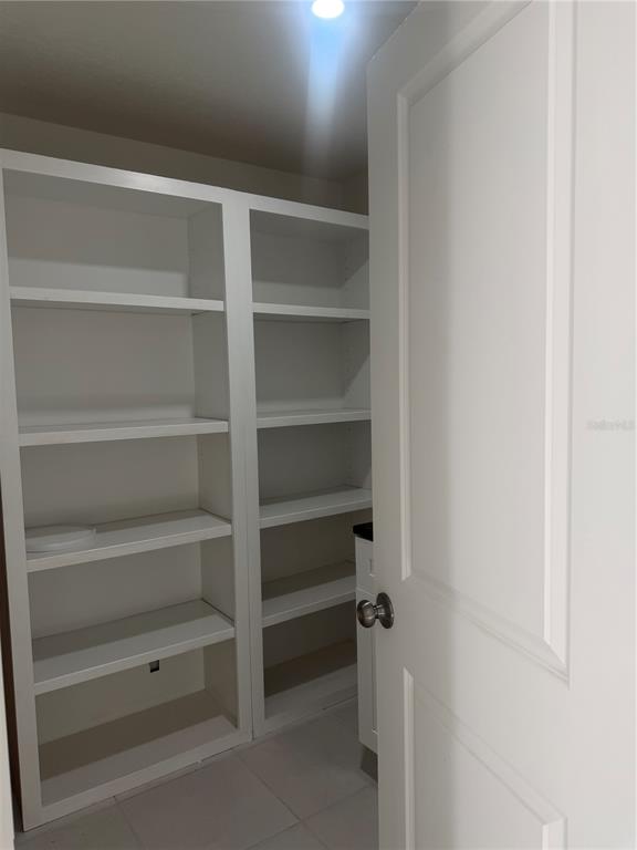 3444 Packard Avenue St. Cloud, FL 34772 - Photo 17 of 28 a view of walk in closet with empty racks