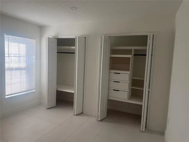 a bathroom with a granite countertop sink a toilet and a shower