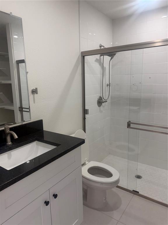 3444 Packard Avenue St. Cloud, FL 34772 - Photo 23 of 28 a bathroom with a granite countertop sink a toilet and shower